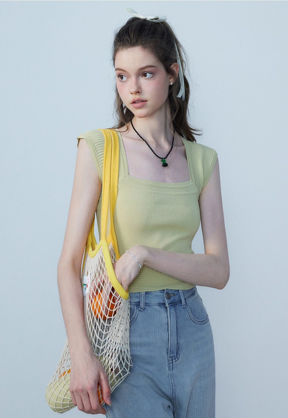 Women's Sleeveless Knit Top in Soft Yellow with Structured Design