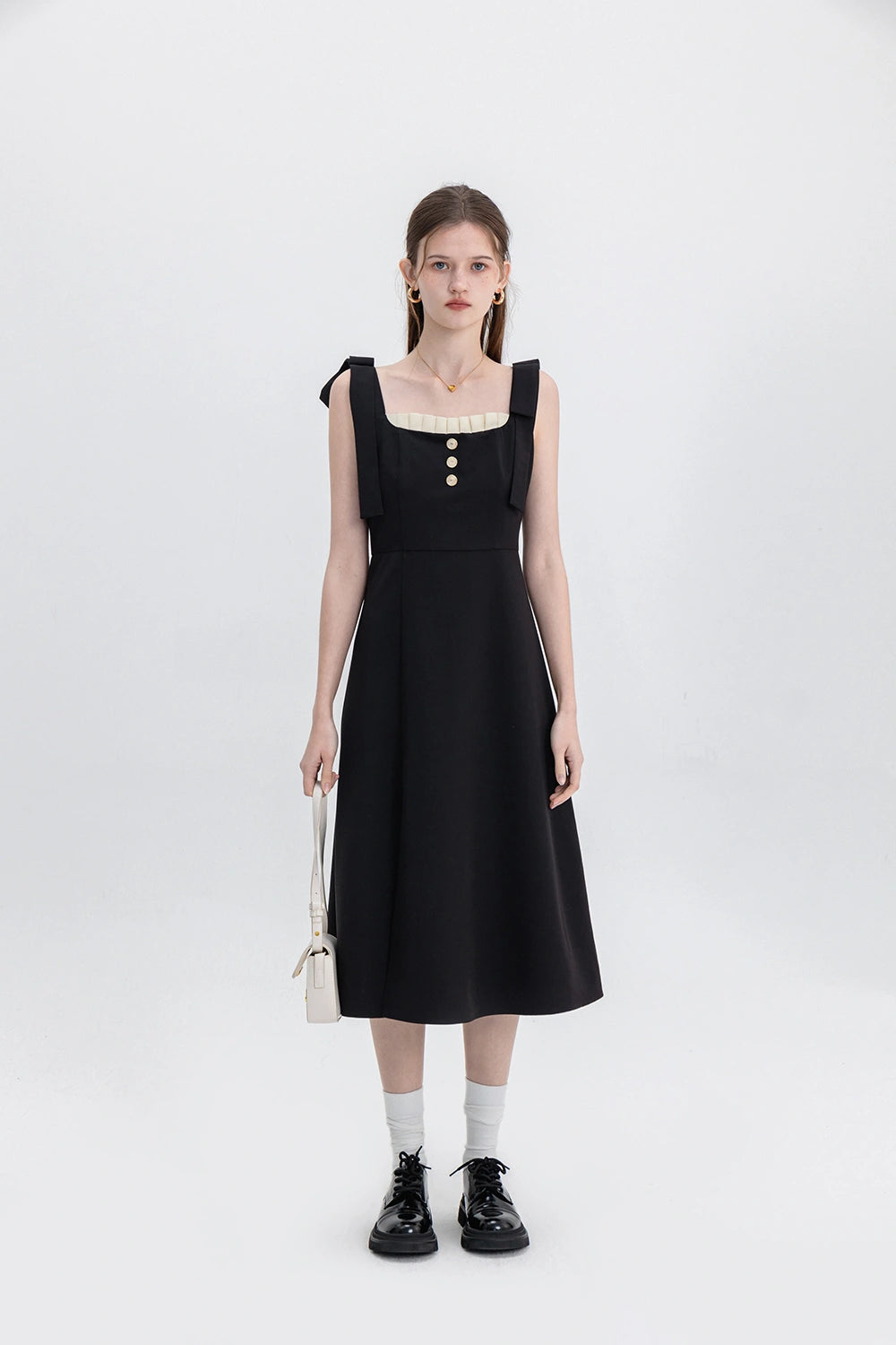 Sophisticated Black Dress with Button Accents and Shoulder Straps