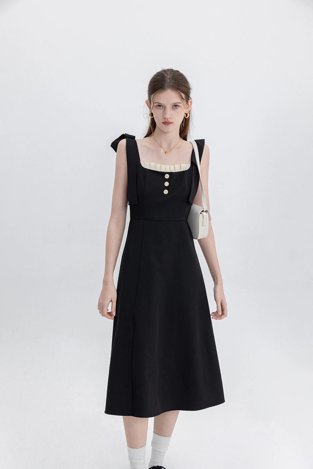 Sophisticated Black Dress with Button Accents and Shoulder Straps