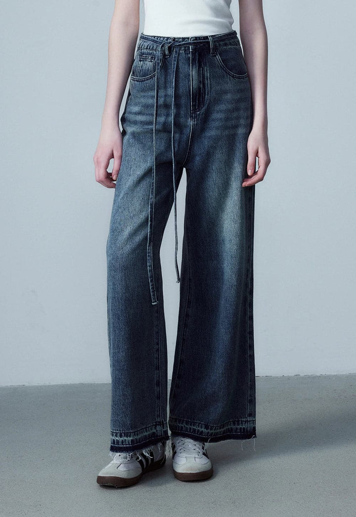 Pantaloni in denim a gamba larga con allacciatura sul davanti da donna